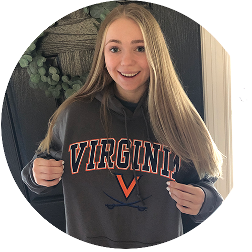 student holding up UVA sweatshirt
