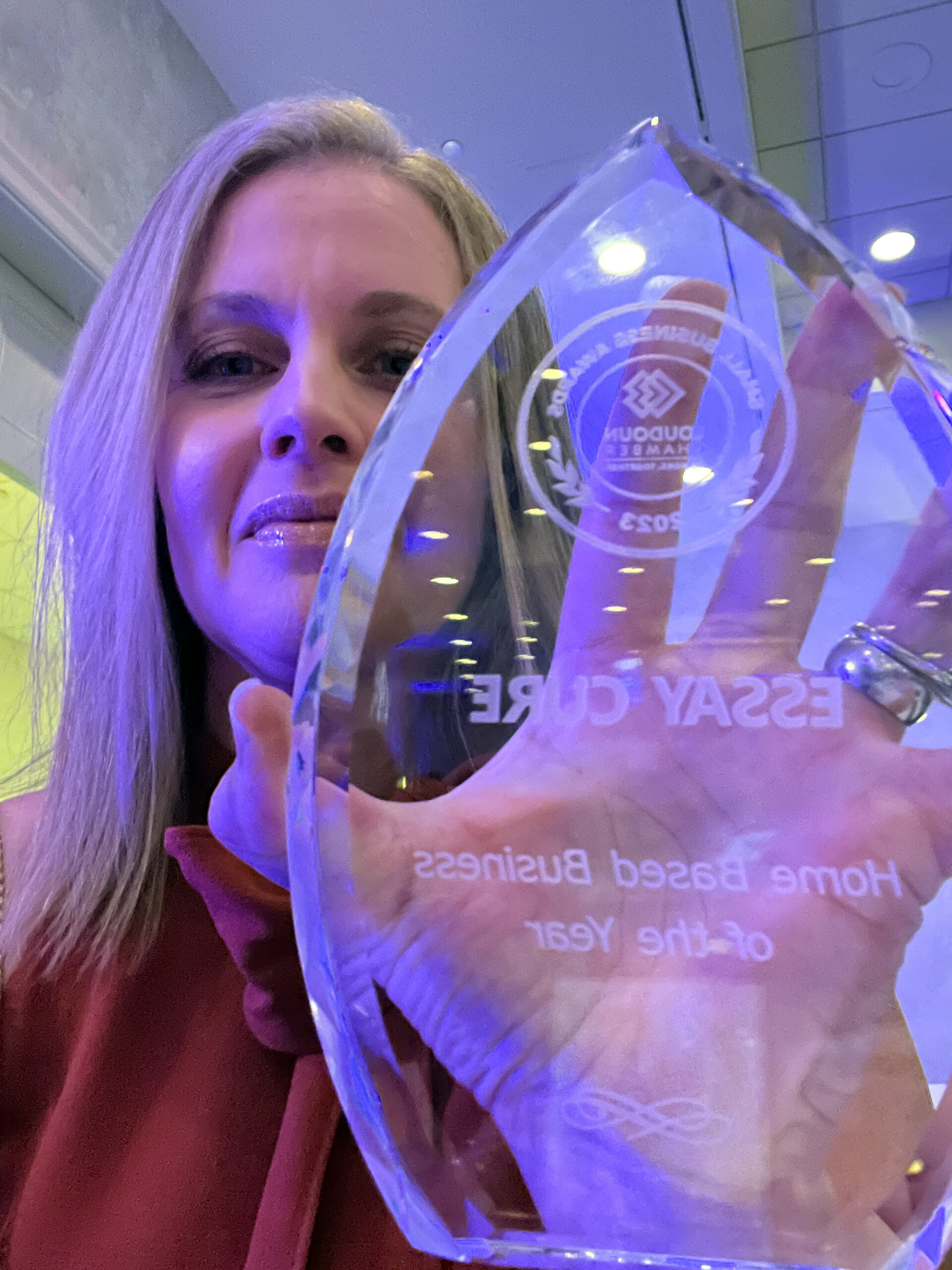 ESSAY CURE won 2023 Loudoun Chamber small business award, owner Christine Gacharná holding up award